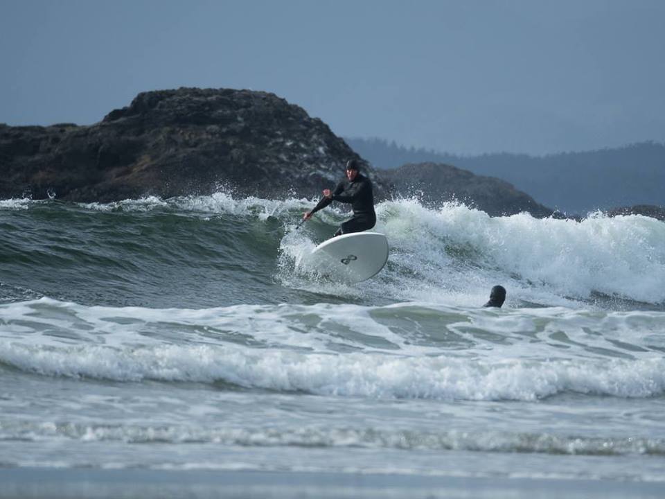 a man riding a wave on a surfboard in the ocean