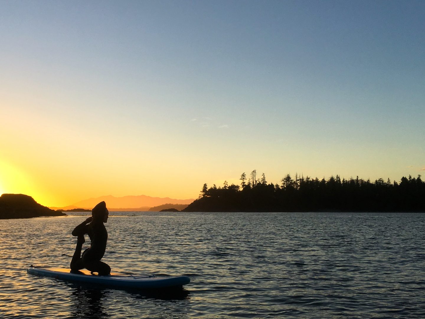 a man riding on the back of a boat in a body of water