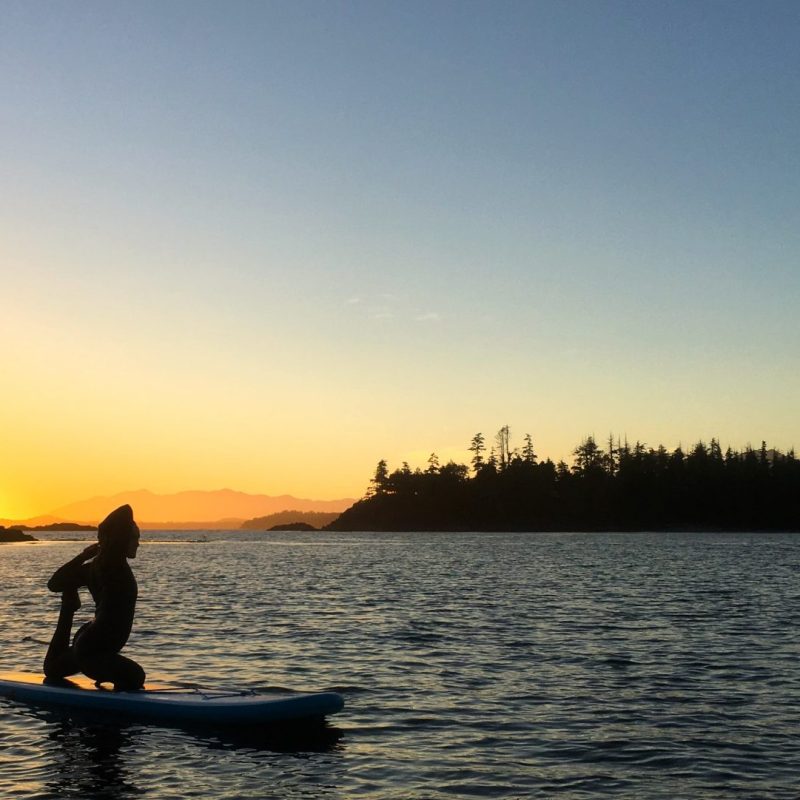 a man riding on the back of a boat in a body of water