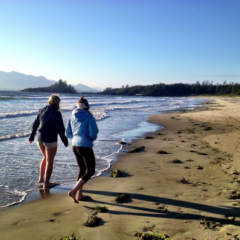 a person standing on top of a sandy beach