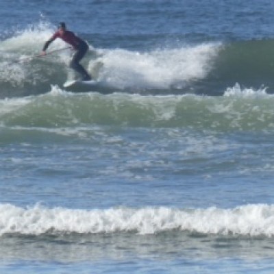 a man riding a wave on a surfboard in the ocean