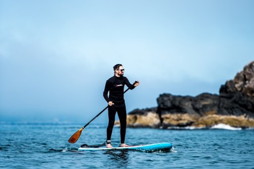 a person riding a surf board on a body of water