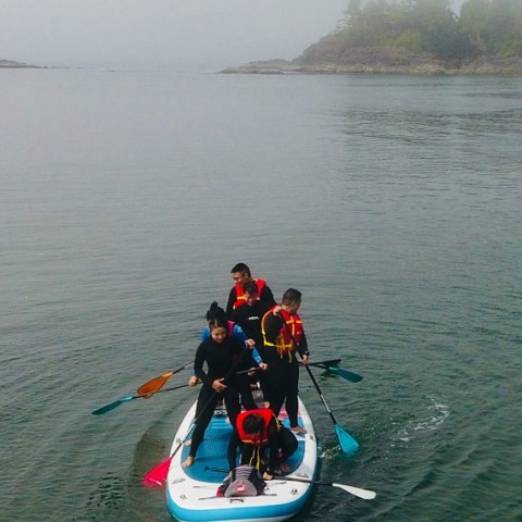 a man riding on the back of a boat in a body of water