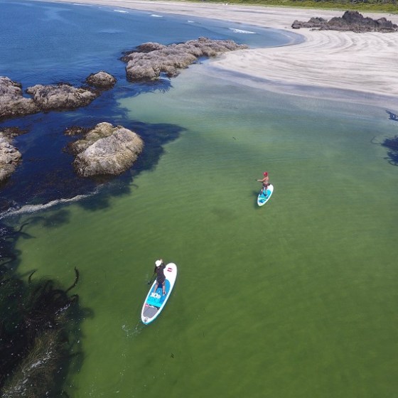 a group of people on a beach near a body of water