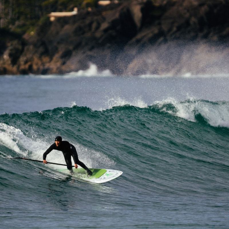 a man riding a wave on a surfboard in the ocean