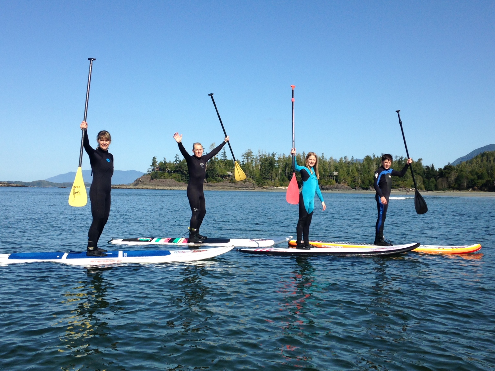 a group of people rowing a boat in the water