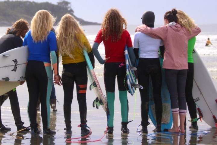 a group of people on a beach posing for the camera