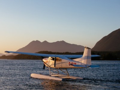 a small boat in a body of water with a mountain in the background