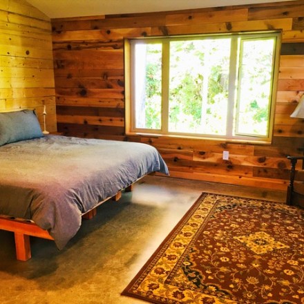 a bedroom with a bed in a room