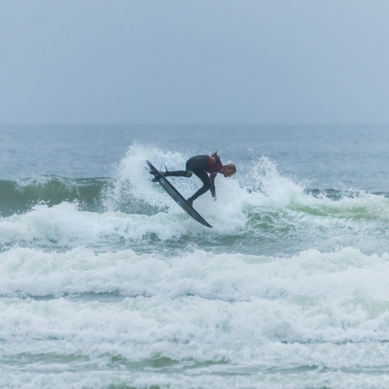 a man riding a wave on a surfboard in the ocean