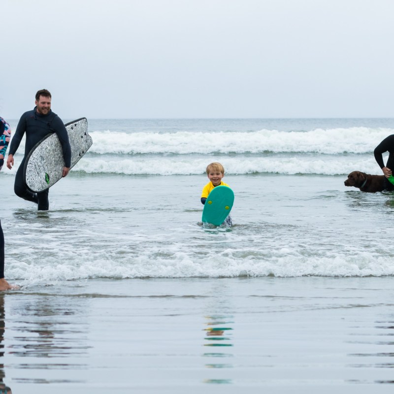 a couple of people that are surfing in the ocean