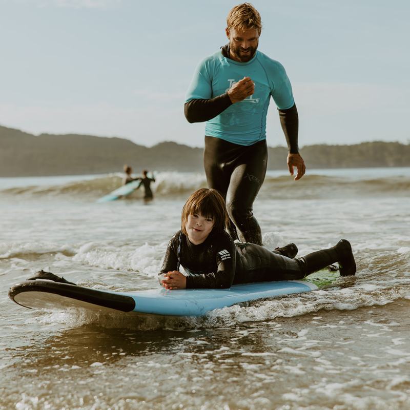 a person riding on the back of a boat on a body of water
