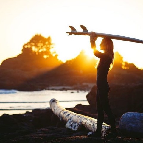 a person sitting in front of a sunset