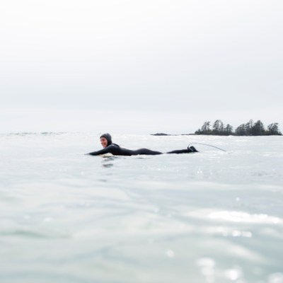 a man riding a snow board on a body of water