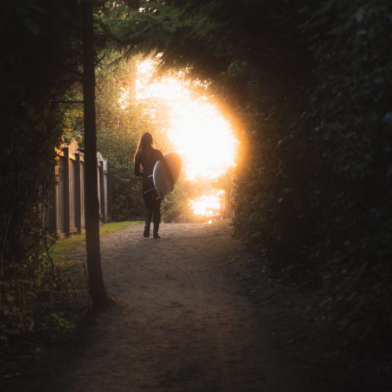 a man standing in front of a sunset